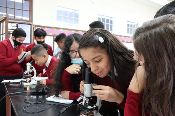 st joan of arc students with microscopes